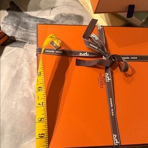 Hermes Orange Gift Box with Brown Ribbon and Yellow Measuring Tape